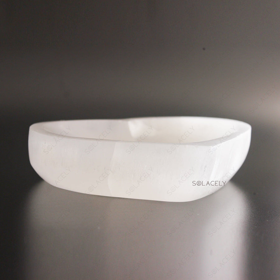 Selenite Heart Bowl on textured black background