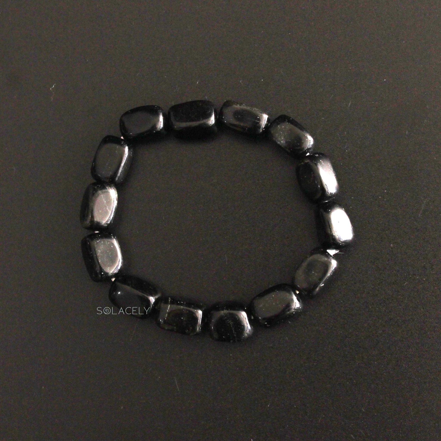Black Tourmaline Tumble Crystal Bracelet on black texture background