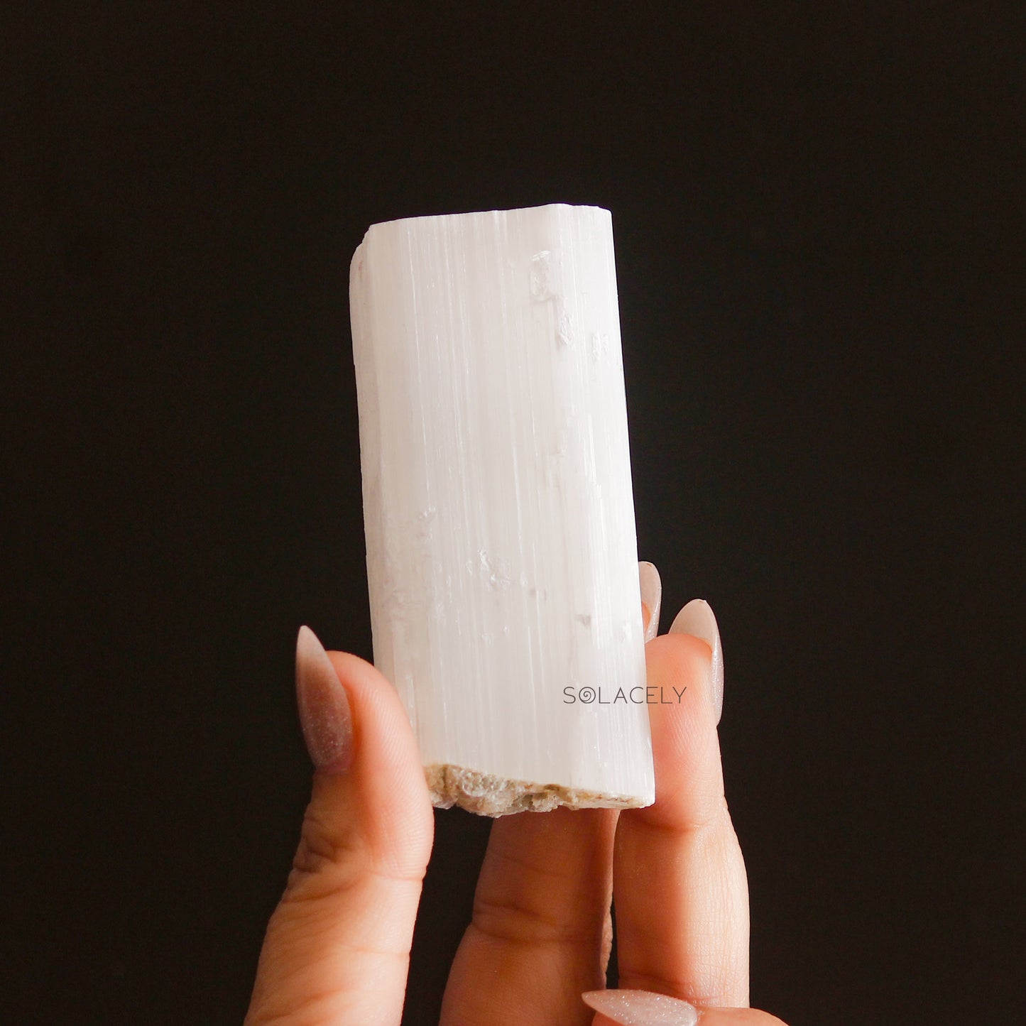 Hand holding Selenite Raw Stones