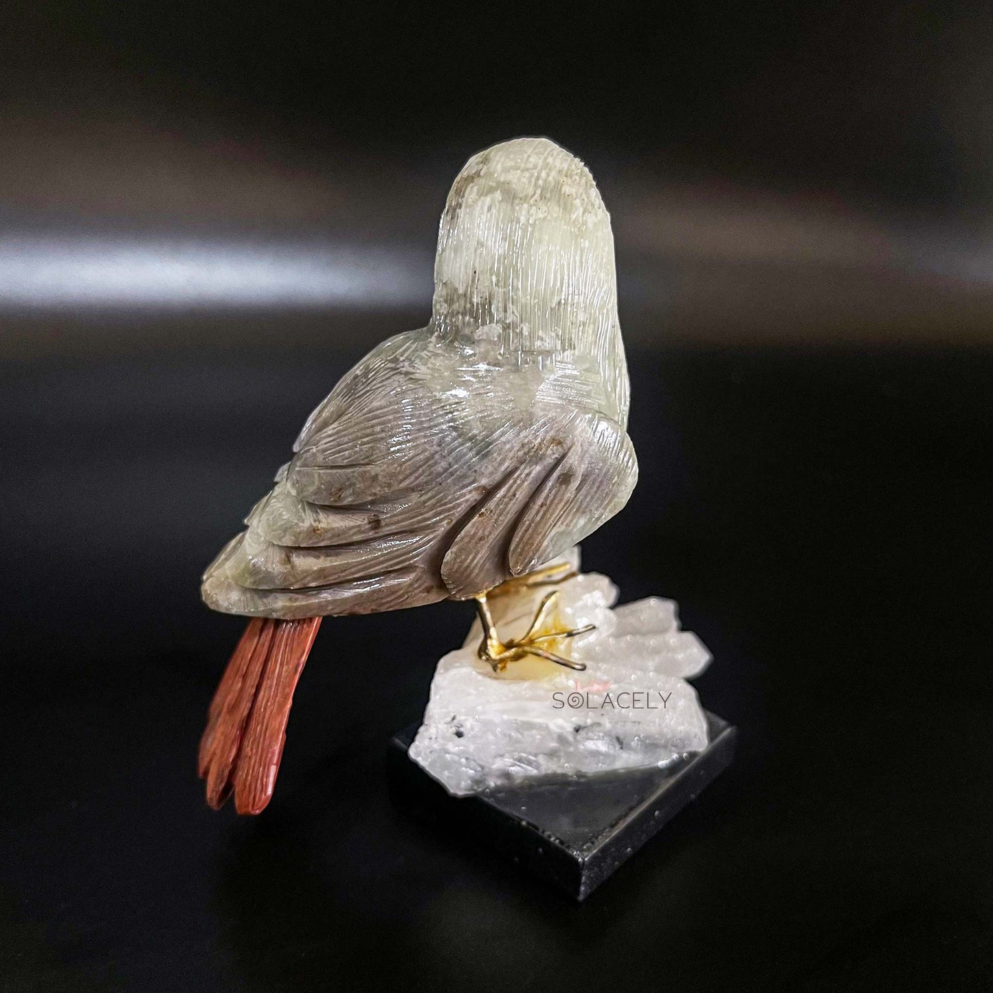 Bird figurine on crystal rock