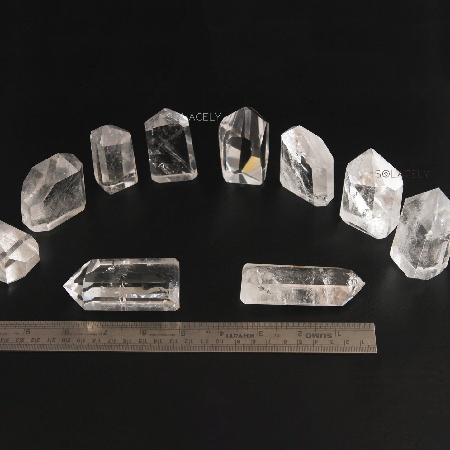 Polished clear quartz points collection with size Guide