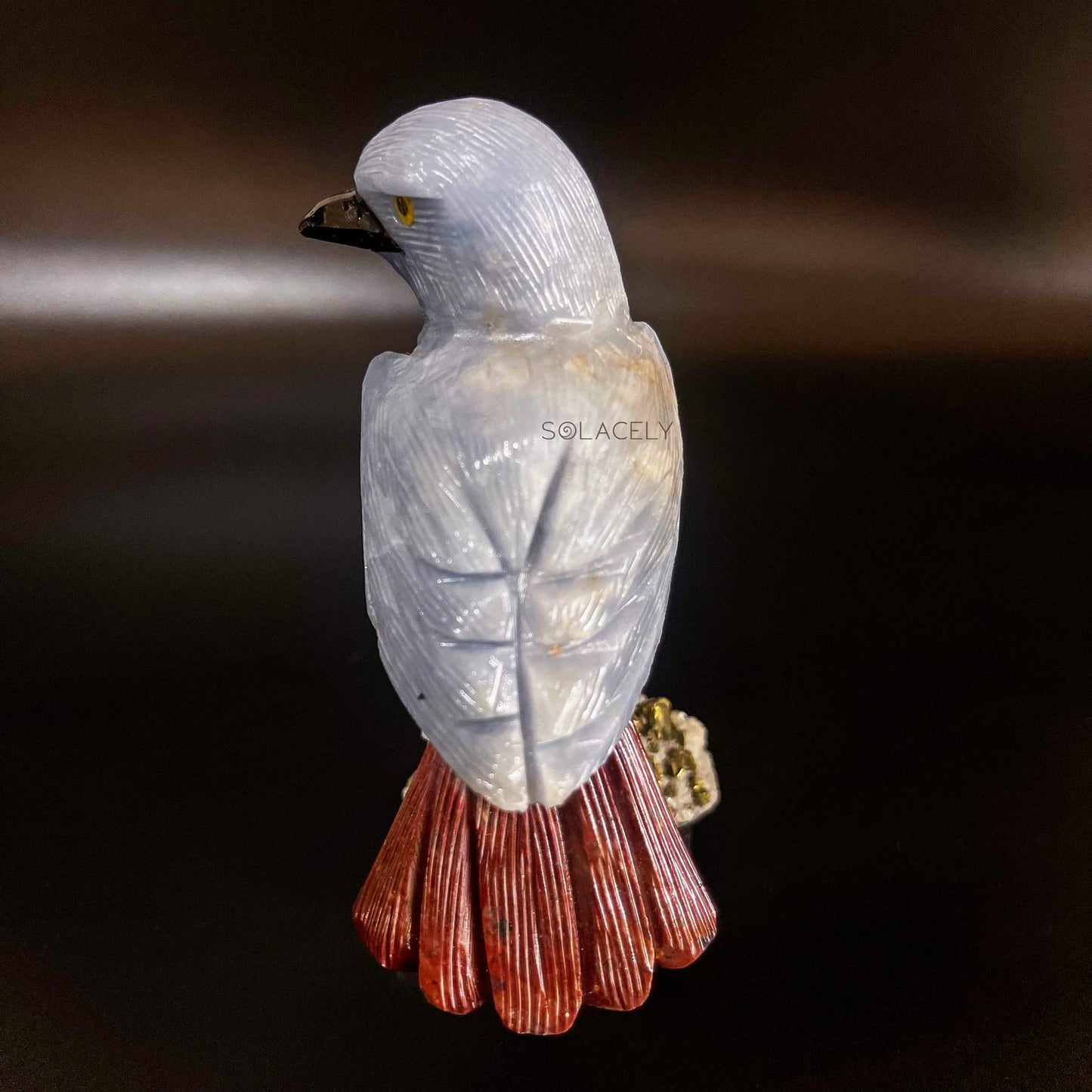 Decorative gemstone bird on stone