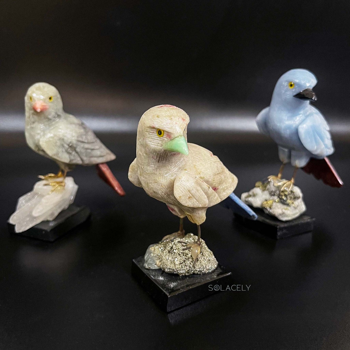 Shiny crystal bird on polished stone