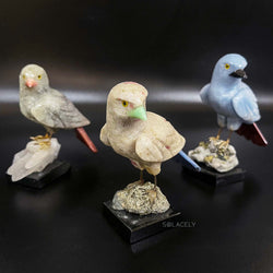 Shiny crystal bird on polished stone