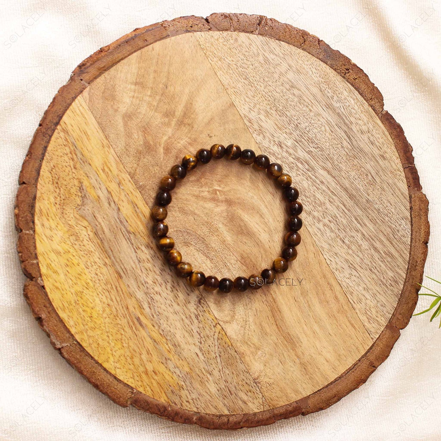 Tiger's Eye Crystal 6mm Beads Bracelet on wooden base