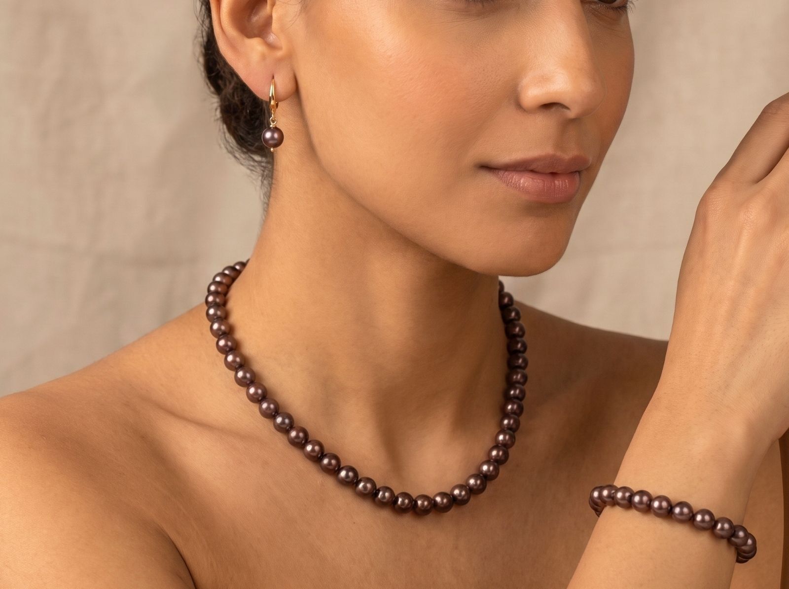 Woman in warm sunlight wearing stacked crystal bead bracelets