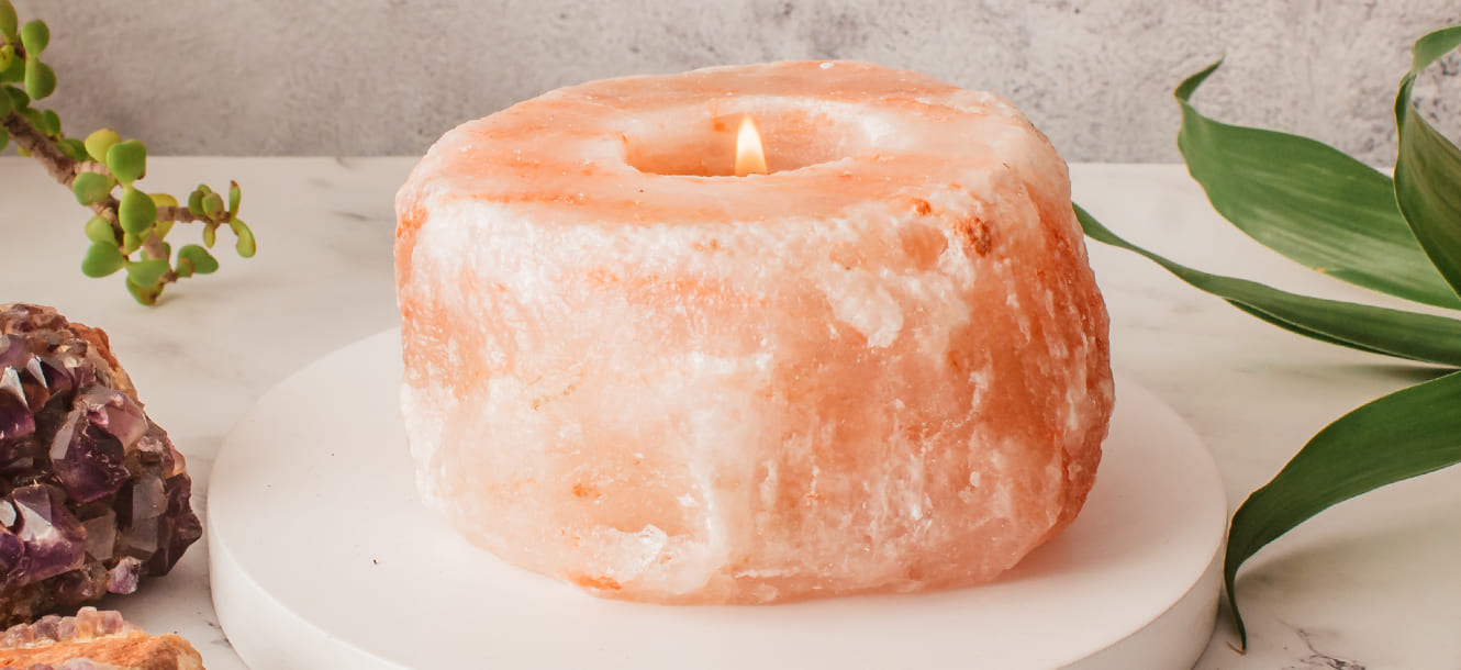 Crystal candle holder glowing on a warm evening shelf