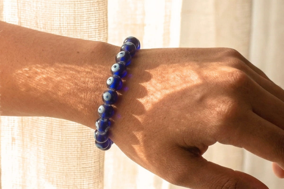 Stacked crystal bead bracelets worn on two wrists
