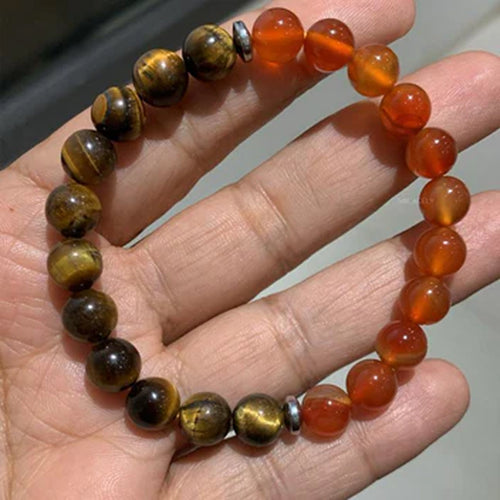 Orange gemstone bracelet held in a hand