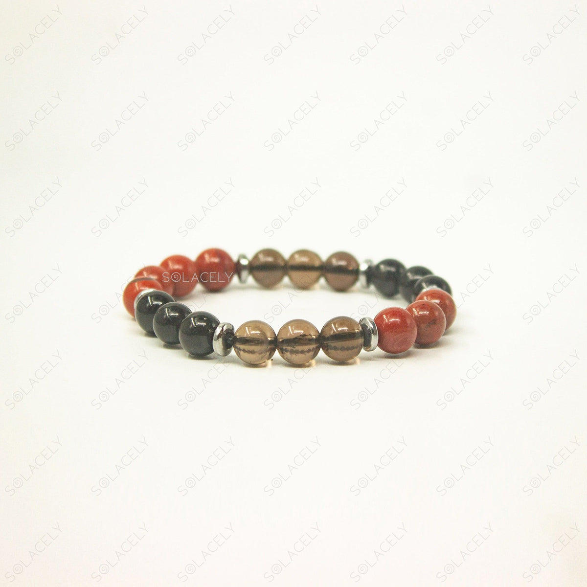 Root Chakra Crystal Bracelet with red, black, and brown stones.