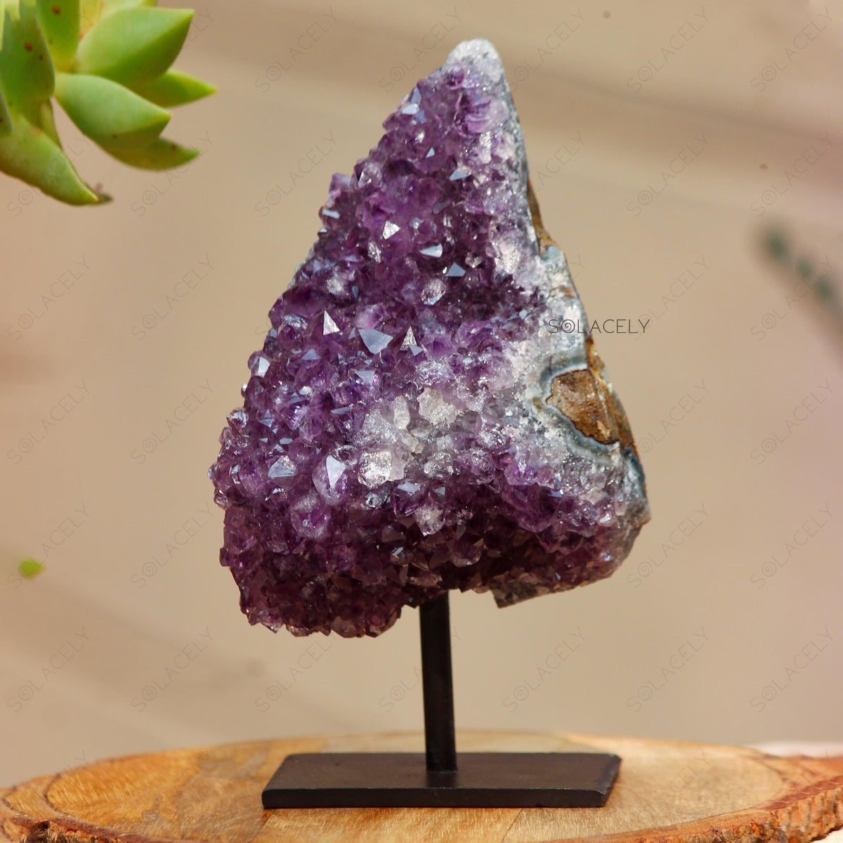 Purple crystal geode on stand.