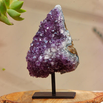 Purple crystal geode on stand.