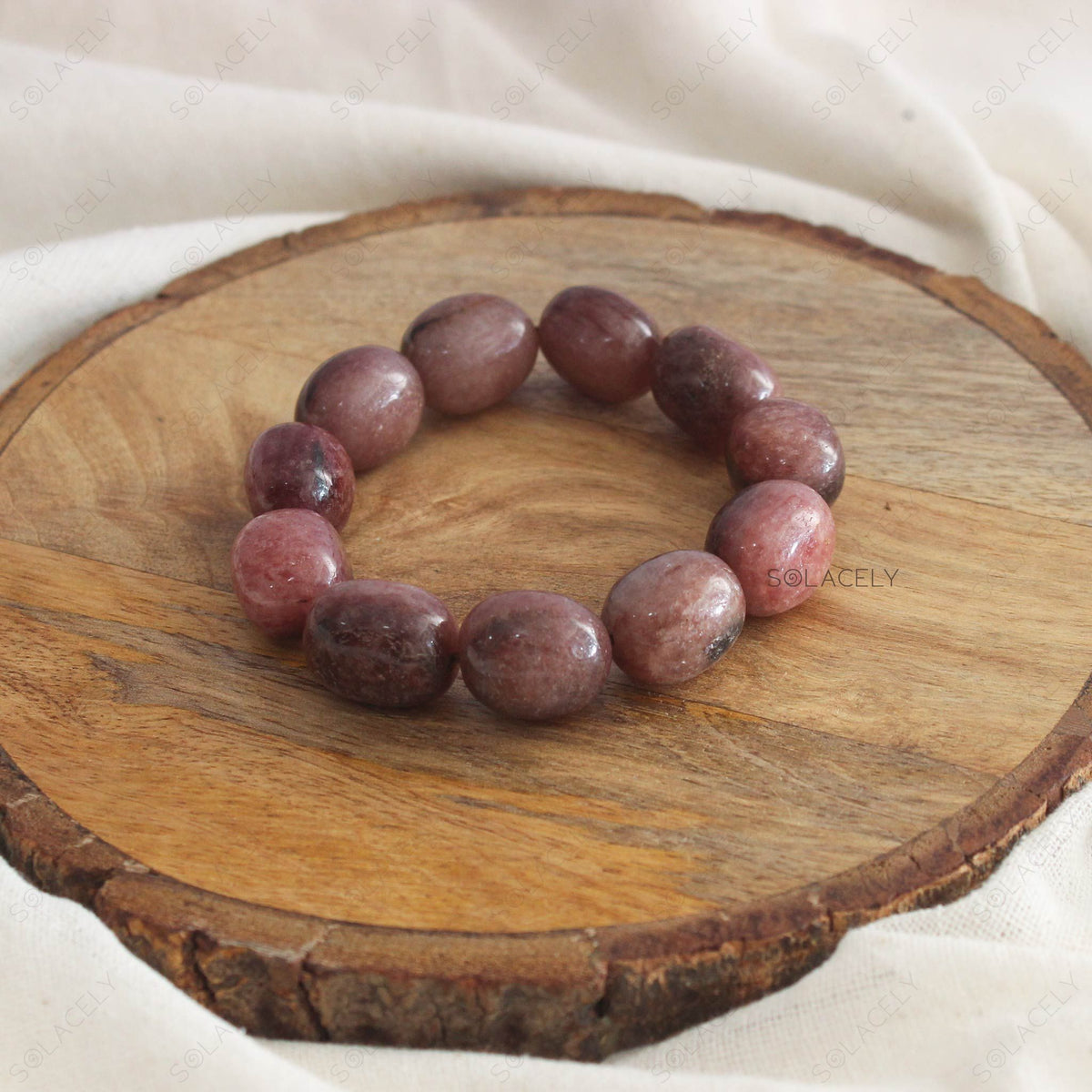 Strawberry Quartz Tumble Crystal Bracelet on wooden base