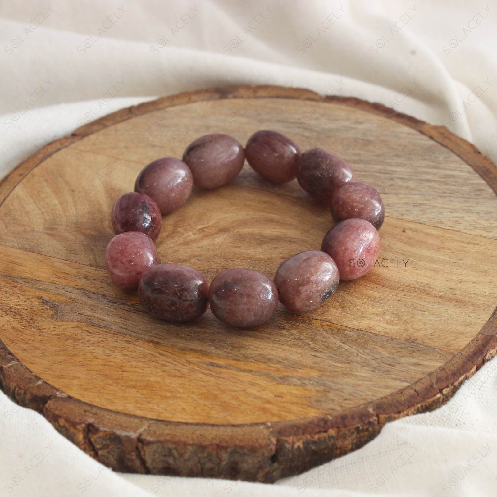 Strawberry Quartz Tumble Crystal Bracelet on wooden base
