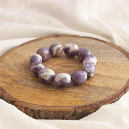 Amethyst Tumble Crystal Bracelet on wooden base