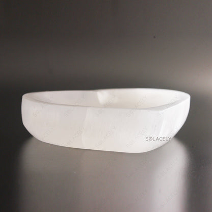 Selenite Heart Bowl on textured black background