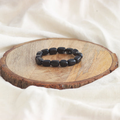 Black Tourmaline Tumble Crystal Bracelet on wooden base