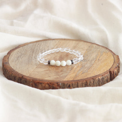 Clear Quartz and Mother of Pearl Bracelet on wooden base