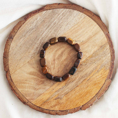Tiger's Eye Tumble Crystal Bracelet on round wooden base