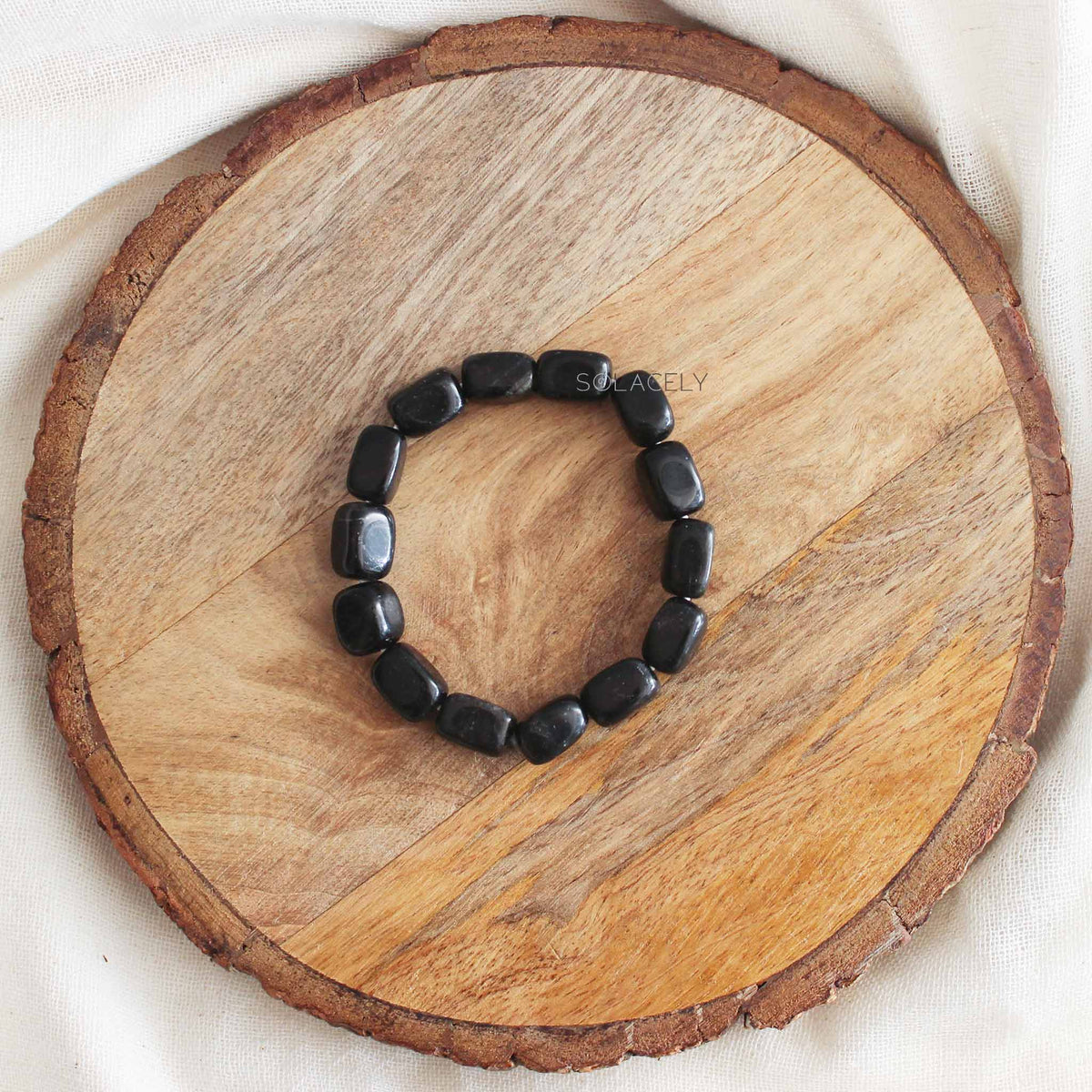 Black Tourmaline Tumble Crystal Bracelet on round wooden base