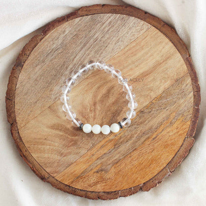 Clear Quartz and Mother of Pearl Bracelet on round wooden base