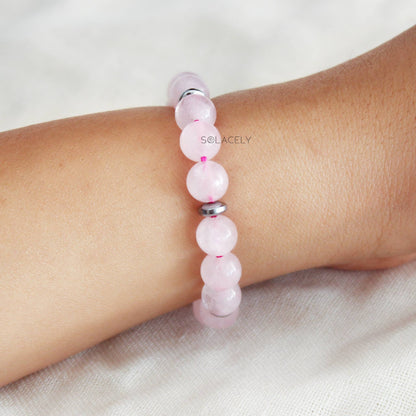 Hand adorned with rose quartz bracelet