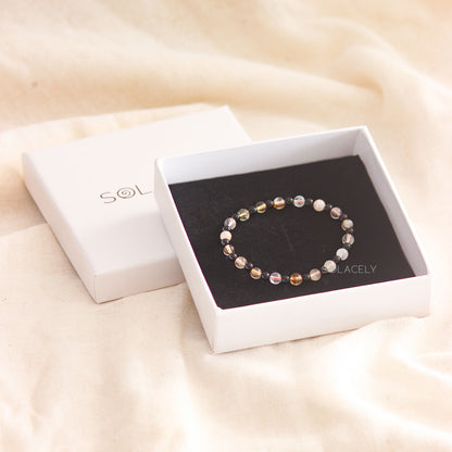 Delicate beaded bracelet in white box.