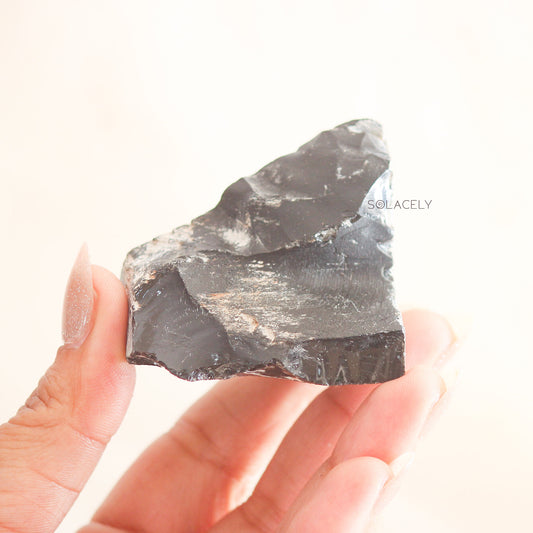 Raw black obsidian stones