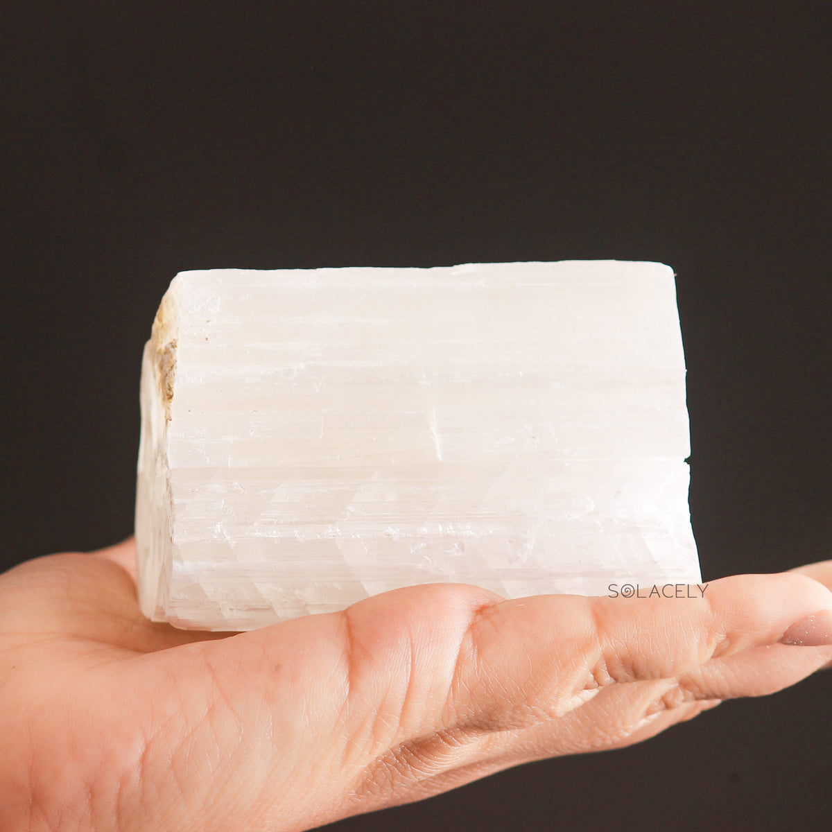 Raw Selenite block in hand