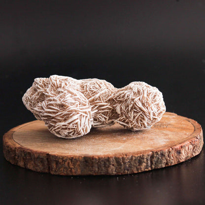 selenite rose cluster on round wooden platform