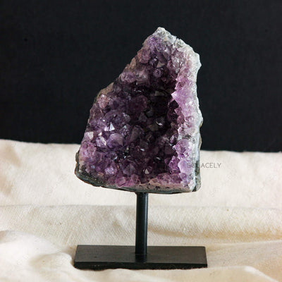 Purple amethyst geode on stand