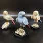 Crystal bird sculpture on stone base