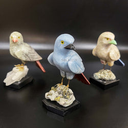 Crystal bird sculpture on stone base