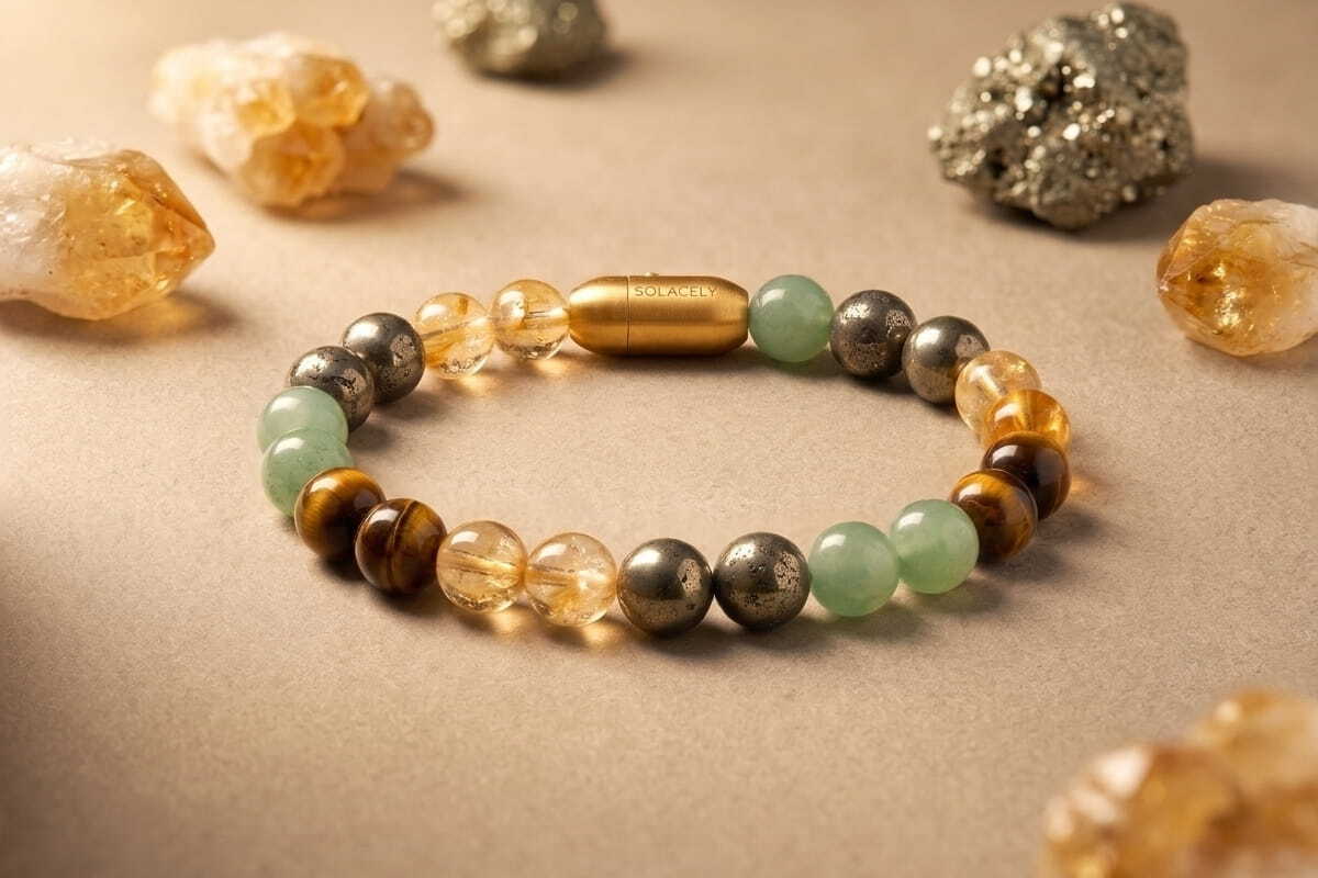 Solacely crystal bead bracelet laid beside raw citrine and pyrite stones