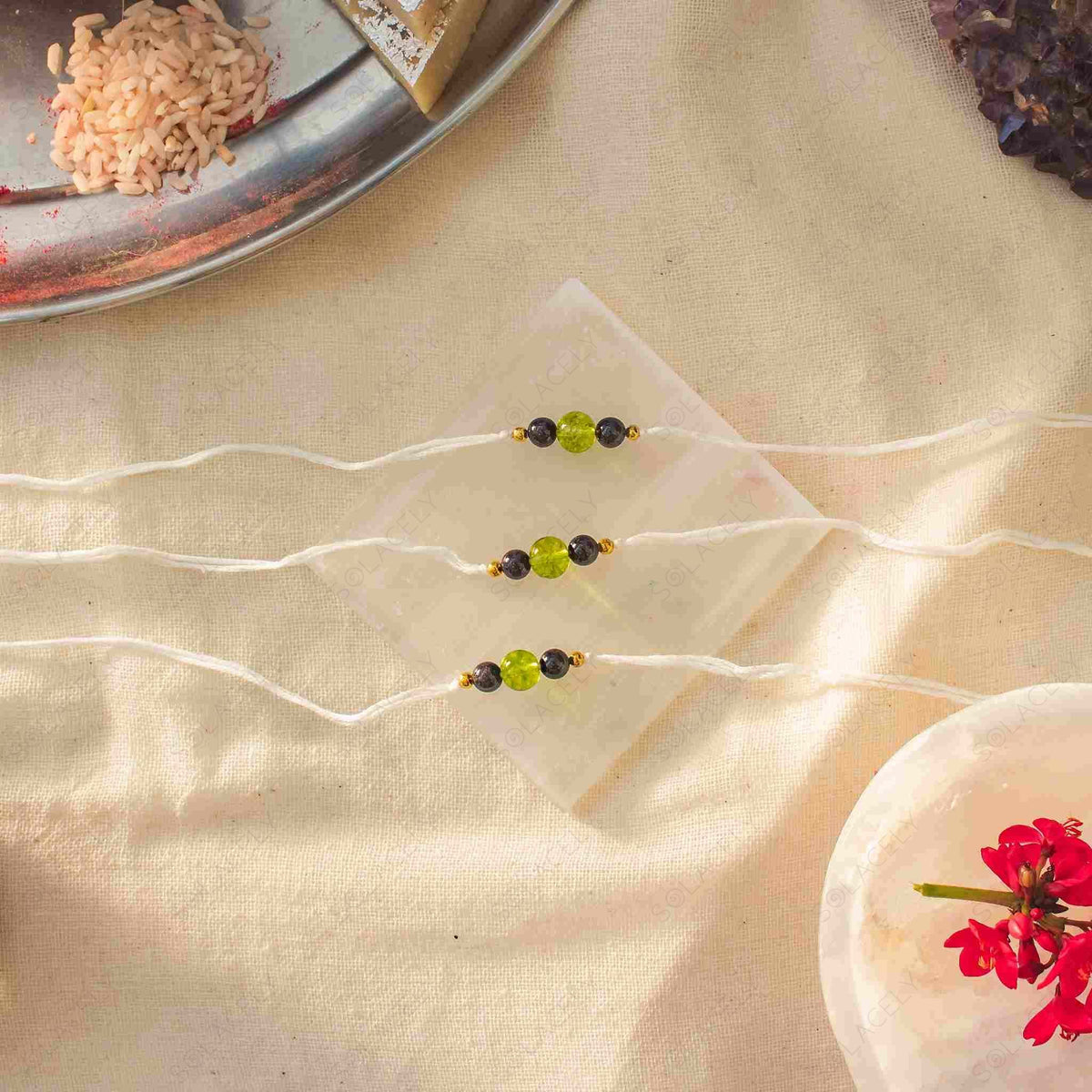 peridot and red garnet rakhi