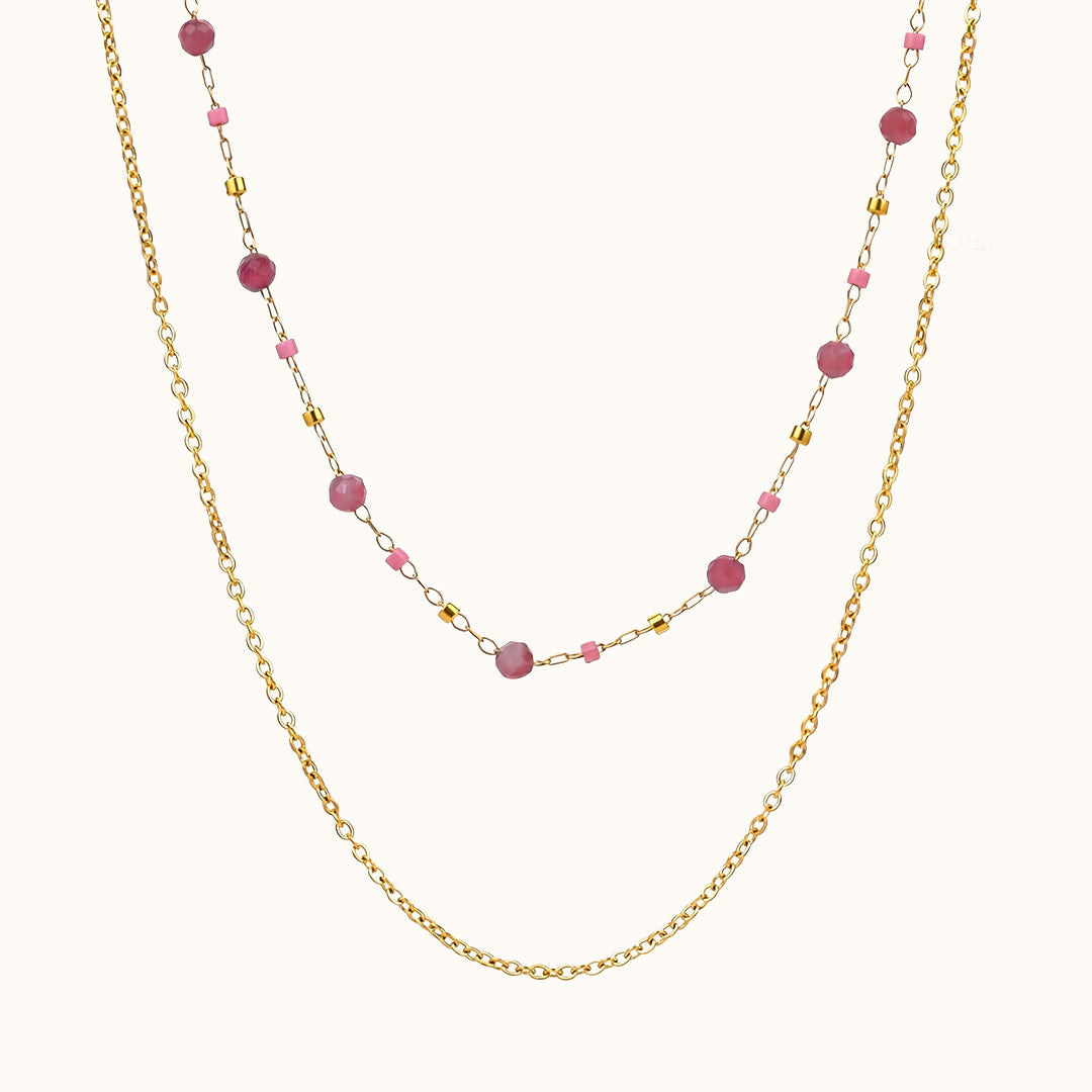 Pink tourmaline beaded layered chain necklace on a soft cream background