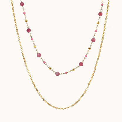 Pink tourmaline beaded layered chain necklace on a soft cream background