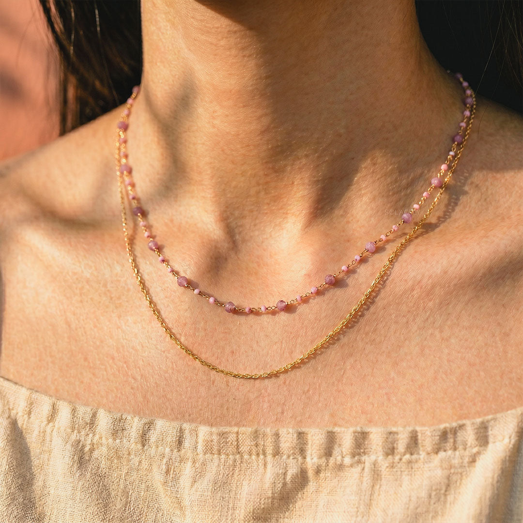 Layered pink tourmaline beaded chain necklace worn on the neckline