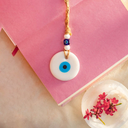 white evil eye wall decor